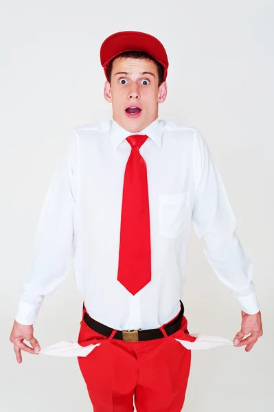 Funny young man showing empty pockets — Stock Photo, Image