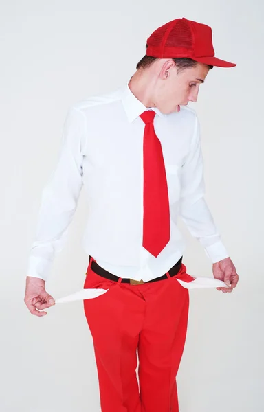 Young man showing empty pockets — Stock Photo, Image