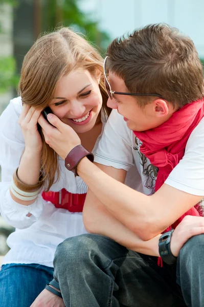 Couple of teenagers talking on the phone — Stock Photo, Image