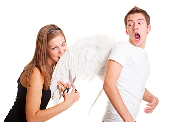 Girl cuting wings of her boyfriend — Stock Photo, Image