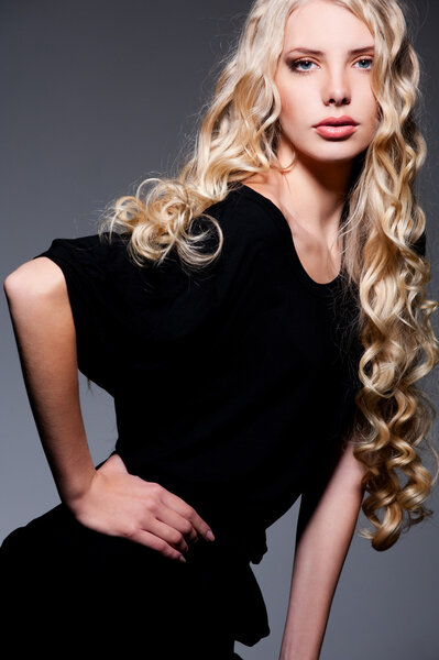 Portrait of alluring blonde with long curly hair