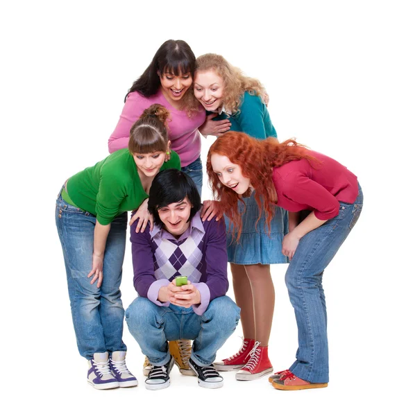 Friends looking at cellphone and laughing — Stock Photo, Image