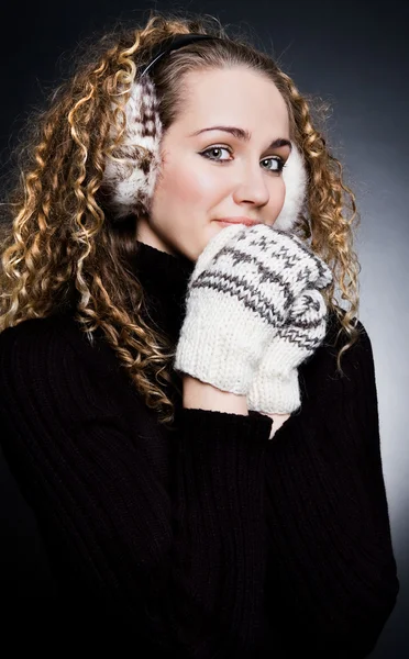 Beautiful blond in headphones and mittens — Stock Photo, Image