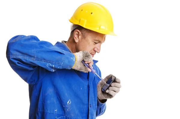 Handsome workman fixing mobile phone with screwdriver — Stock Photo, Image
