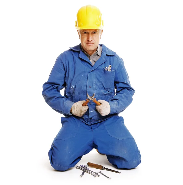 Handsome workman sitting against white — Stock Photo, Image