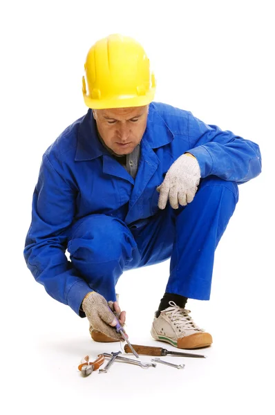 Senior workman selects the tools — Stock Photo, Image