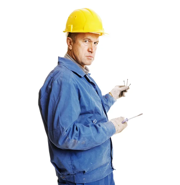 Serious worker with screws and screwdriver — Stock Photo, Image