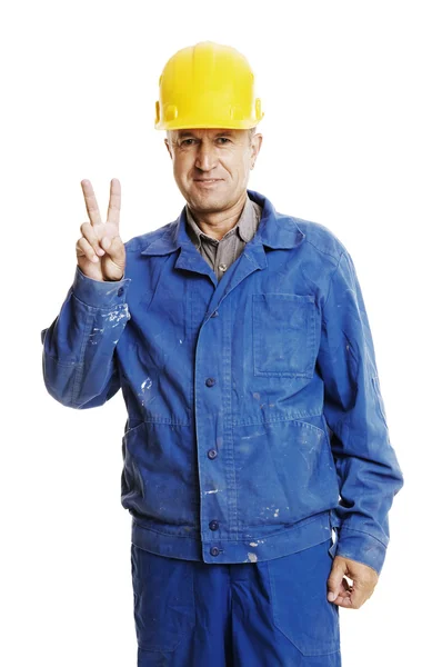 Smiley-Arbeiter zeigt Siegeszeichen — Stockfoto