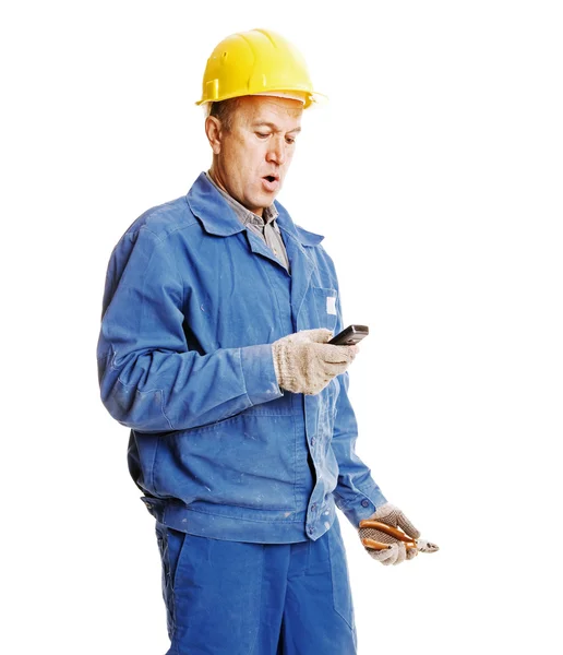 Surprised workman reading message — Stock Photo, Image