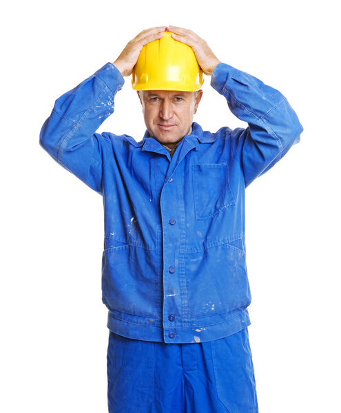 Worker with hands on his hardhat
