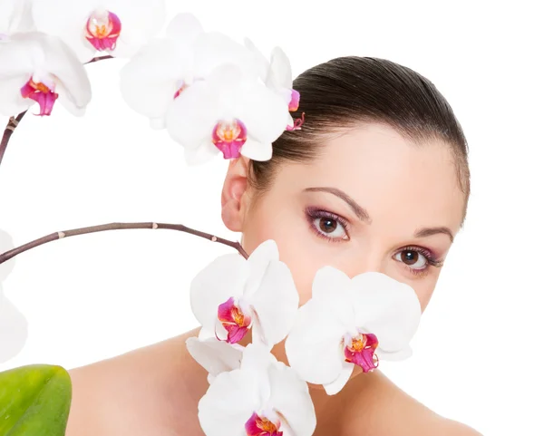 Beautiful young woman with orchid — Stock Photo, Image