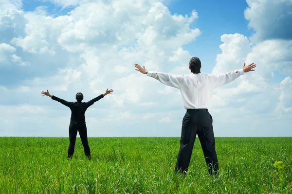 Businesspeople standing on green grass — Stock Photo, Image