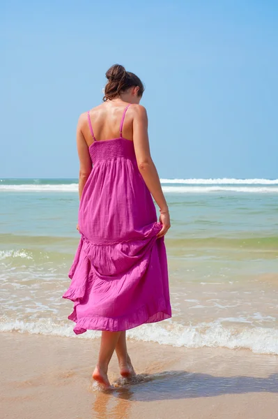 Attractive woman walking in to the ocean — Stock Photo, Image