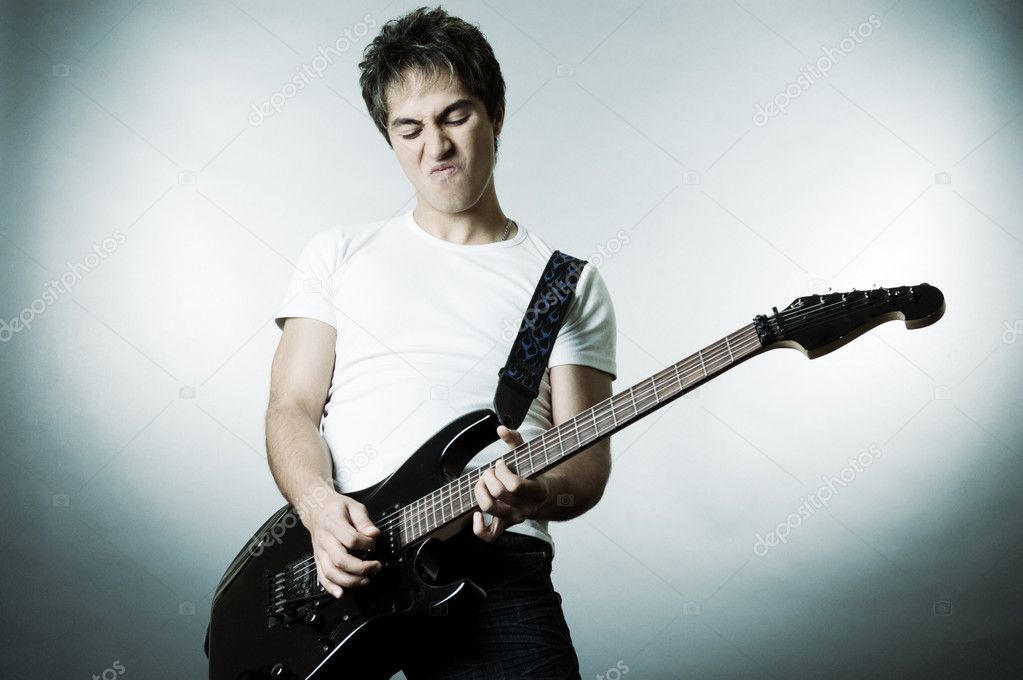 Handsome man playing on the guitar
