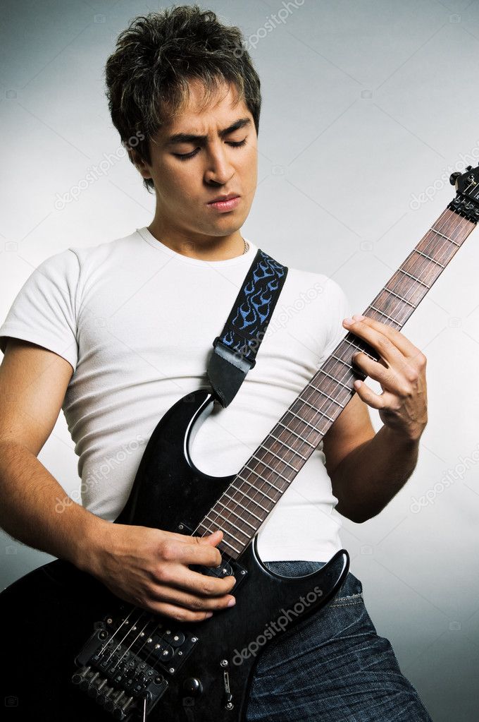Young man playing on the guitar