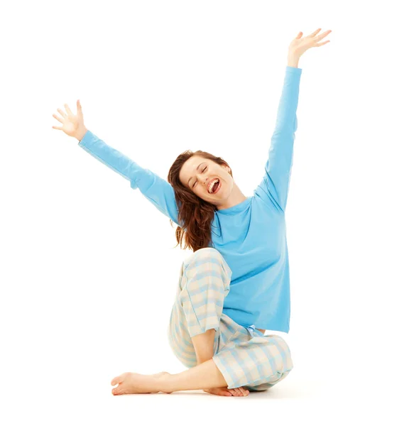 Happy young woman in blue pyjamas — Stock Photo, Image
