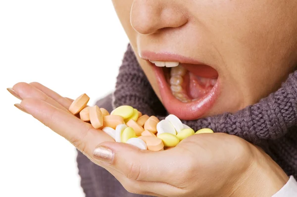 Mulher tomando pílulas sobre branco — Fotografia de Stock