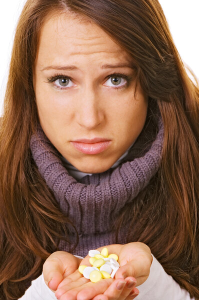 Woman with pills on her hands