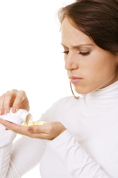 Young woman pouring pills in her hand — Stock Photo, Image