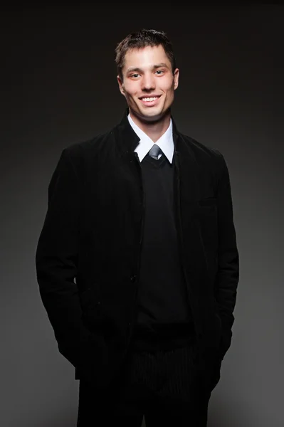 Handsome smiley man over dark background — Stock Photo, Image
