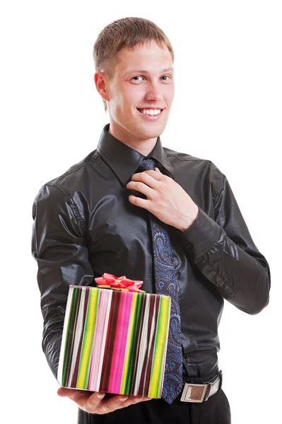 Handsome smiley man holding gift — Stock Photo, Image