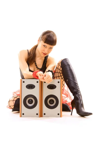 Girl sitting near speakers and staring — Stock Photo, Image