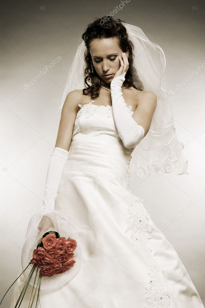 Sad bride with bunch of roses
