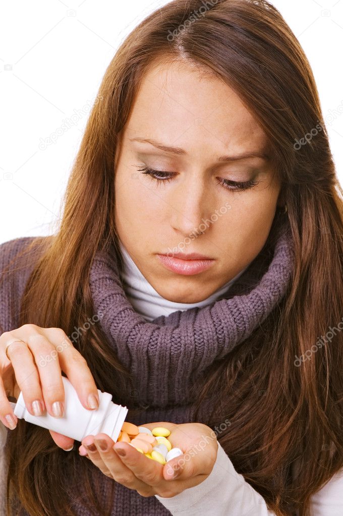 Young woman with bottle of pills