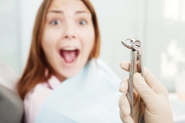 Scared woman at dentist's office clipart