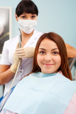 Doctor and patient at dentist's office clipart