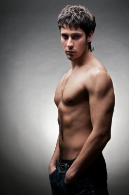 Serious young man with naked torso clipart