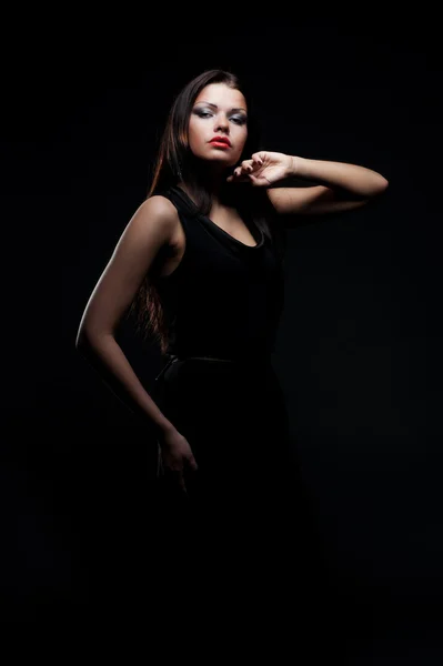 Lovely young woman in darkness — Stock Photo, Image