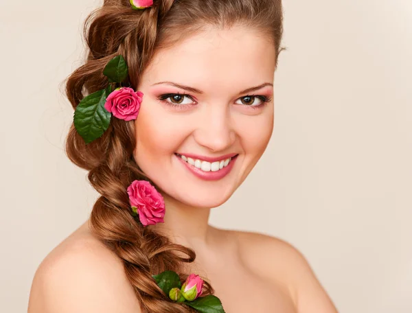 Moder muito sorridente com rosas no cabelo — Fotografia de Stock