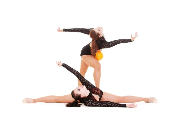 Gymnasts dancing with yellow ball — Stock Photo, Image