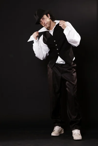 Danser in hoed bedrijf zijn kraag — Stockfoto