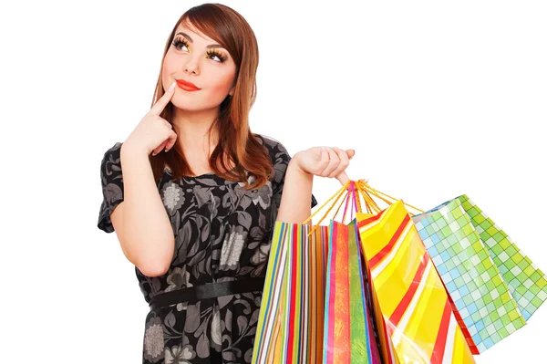 Mujer pensativa sonriente con bolsas de compras —  Fotos de Stock