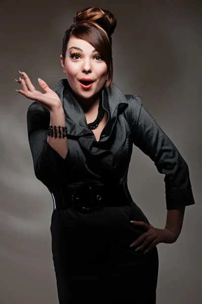 Surprised woman over dark background — Stock Photo, Image