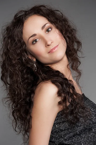 Pretty young woman with long curly hair — Stock Photo, Image