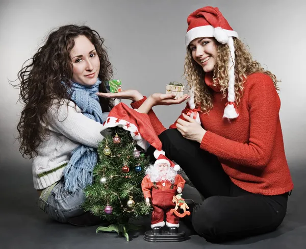 坐在圣诞树旁的两个朋友 — 图库照片