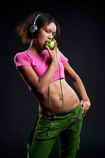 Attractive girl with apple like player — Stock Photo, Image