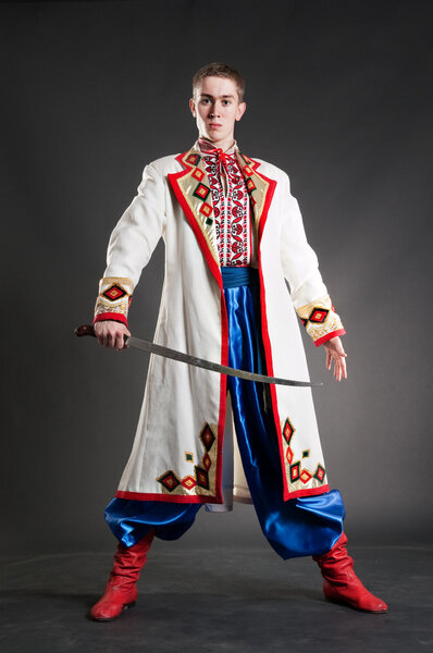 Armed young cossack in national ukrainian dress