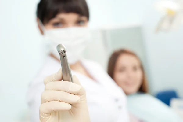 Doctor holding dentist's instrument — Stock Photo, Image