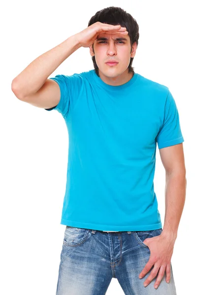 Handsome man in blue t-shirt is scrutinizing — Stock Photo, Image
