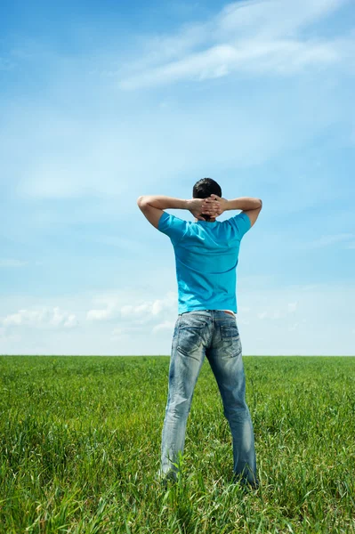 緑の牧草地に立っている人 — ストック写真