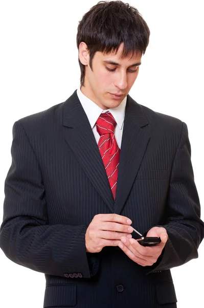 Serious businessman with palmtop — Stock Photo, Image