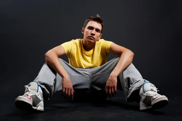 Serious guy sitting on the floor — Stock Photo, Image