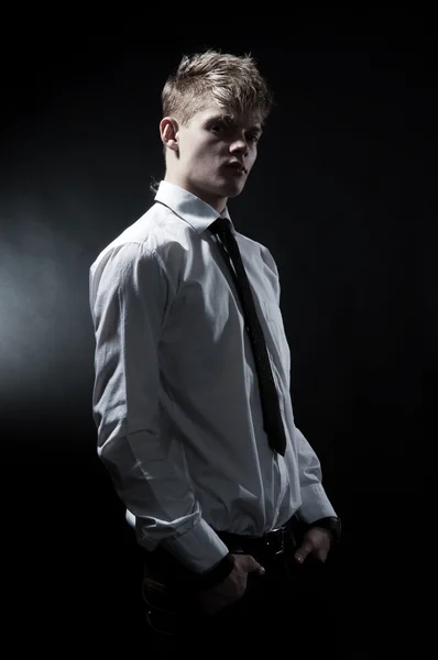 Handsome man against dark background — Stock Photo, Image