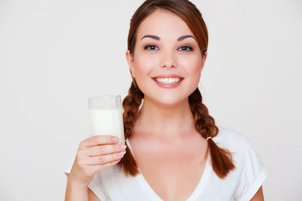 Pretty smiley woman with glass of milk Stock Photo