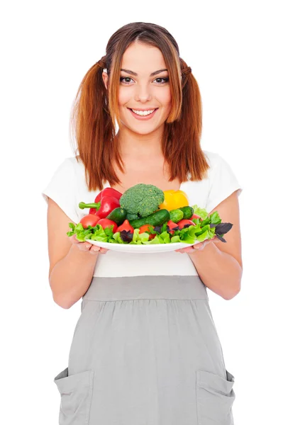 Smiling young woman holding vegetables Stock Picture