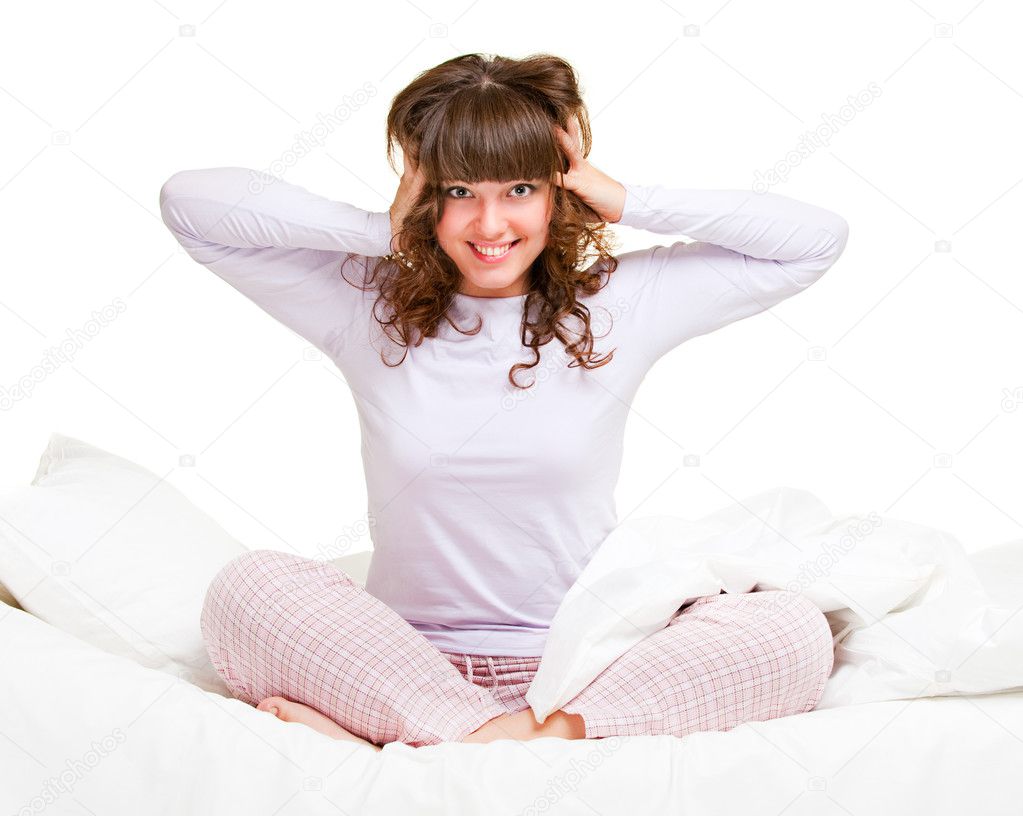 Girl in pajamas sitting in bed